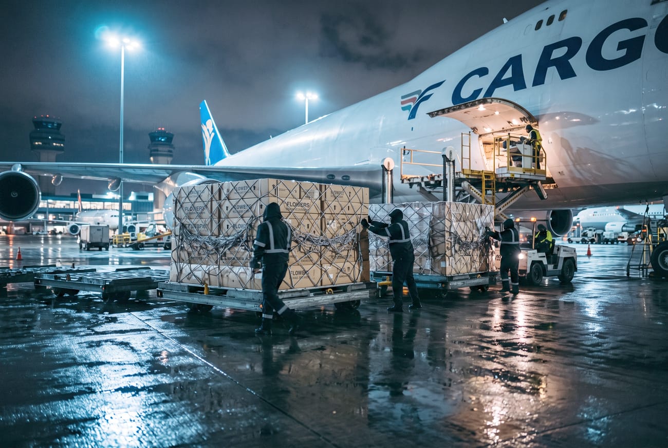 Flower boxes loaded onto a freighter aircraft at night